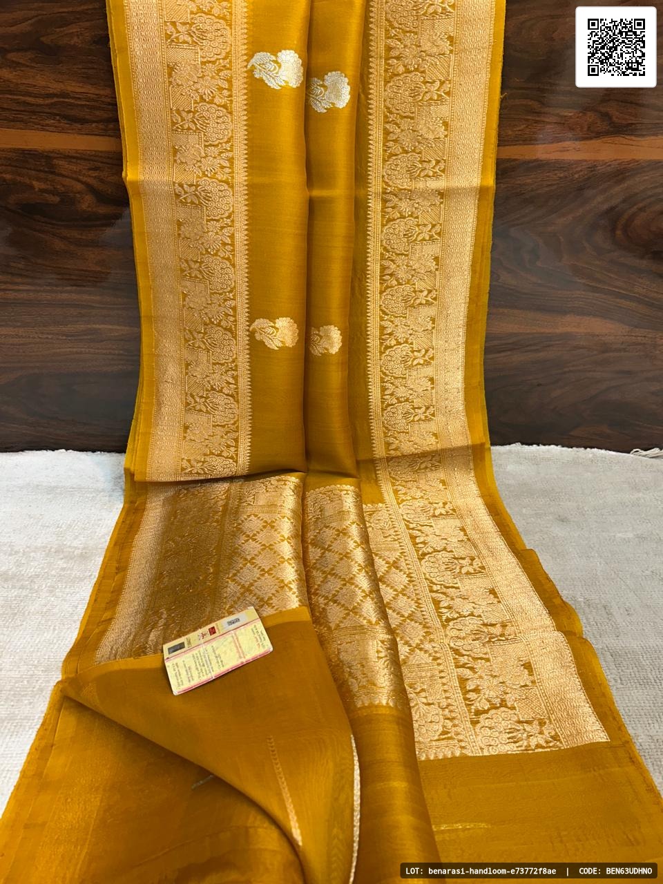 Pure handloom Banarasi Kora saree featuring Kaduwa reshmi zari work. The saree comes with a blouse that has a border and strip, crafted from smooth and soft fabric. Silk Mark certified for quality assurance.