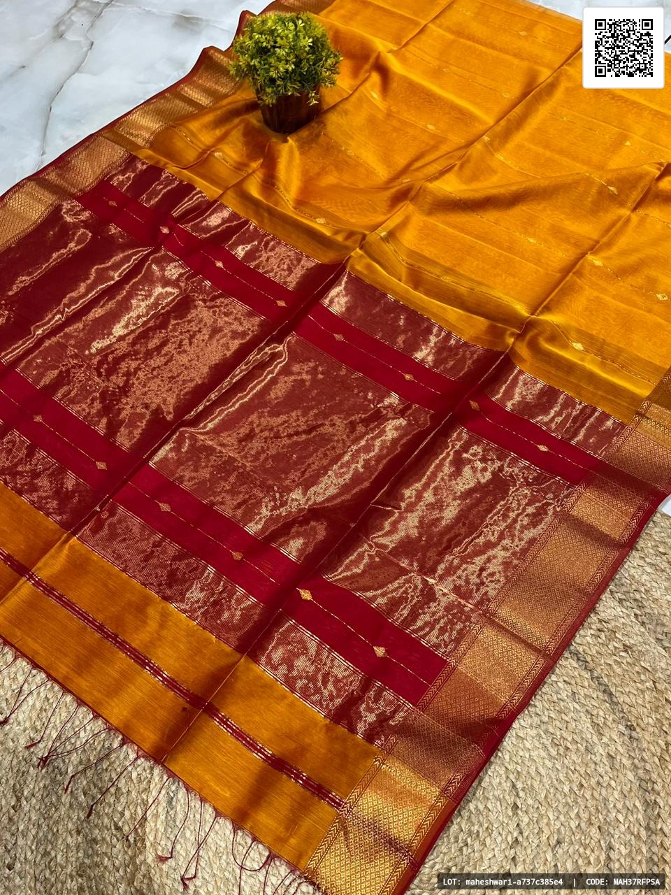 Traditional pure Maheshwari handloom saree featuring a big border with zari line buti design. Crafted from half silk and half cotton, this saree is recommended for dry clean only. A perfect choice for festive occasions and special gatherings.
